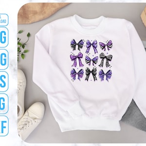 May include: White sweatshirt with a design of purple and black bows on the front.