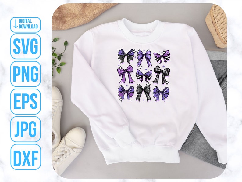 May include: White sweatshirt with a design of purple and black bows on the front.