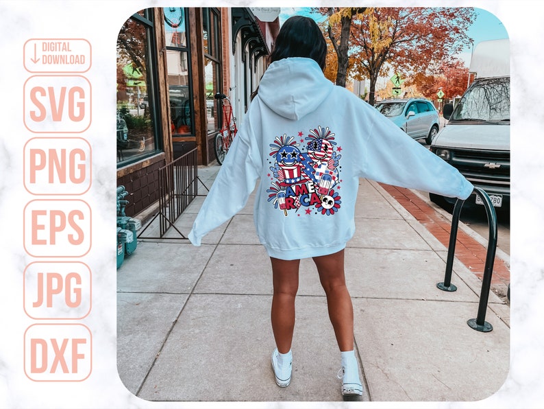 May include: A light blue hoodie with a graphic design on the back. The design features a cartoon-style American flag, fireworks, and the word "America".