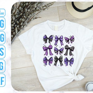 May include: A white t-shirt with a design of purple and black bows with white polka dots. The bows are arranged in a grid pattern.