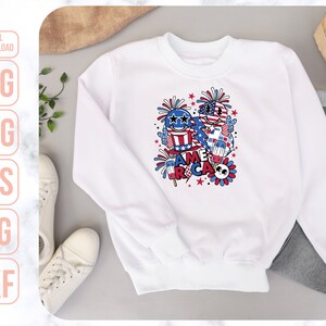 May include: White sweatshirt with a red, white, and blue graphic design featuring cartoon characters, fireworks, and the text "America".