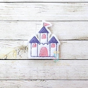 May include: A white castle with purple towers and a pink door. The castle has a small pink flag on top.