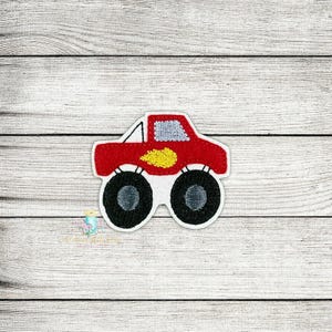 May include: Red monster truck applique with yellow flames and black tires. This embroidered patch is perfect for adding a fun touch to clothing, bags, or other crafts.