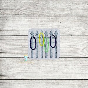 May include: A white picket fence with three green, yellow, and purple circles in the middle.