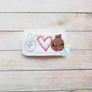 May include: White felt patch with an embroidered peace sign, heart, and winking turkey face. The text "Peace Love Turkey" is embroidered on the patch.