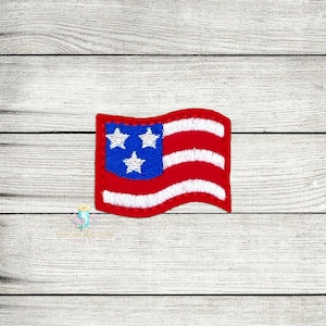 May include: A small, red, white, and blue embroidered American flag patch. The flag is waving in the wind.
