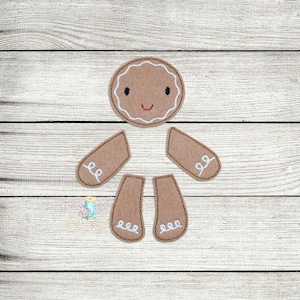 May include: A gingerbread man felt applique set with a brown felt head, arms, and legs. The head has a white icing outline and a smiling face. The arms and legs have white icing swirls.