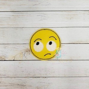 May include: Yellow emoji with a confused expression, with raised eyebrows and a slightly downturned mouth. The emoji has large, white eyes.