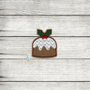 May include: A brown and white Christmas pudding with green holly and a red berry on top.