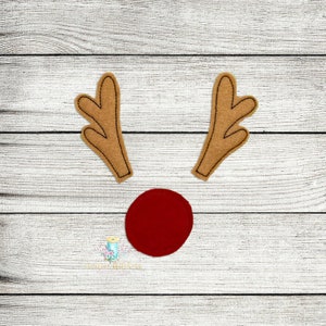 May include: Two brown felt reindeer antlers with a red felt nose.
