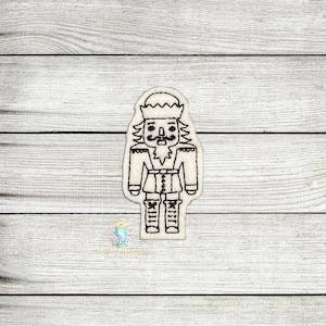 May include: A black and white line drawing of a nutcracker. The nutcracker is wearing a hat, a jacket, and pants. The nutcracker has a mustache and a beard.