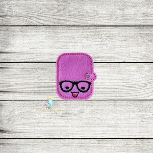 May include: A purple felt patch with a smiling face, wearing glasses and a small blue flower on the side.