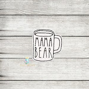 May include: A white coffee mug with a black outline and the text "Mama Bear" on the front.