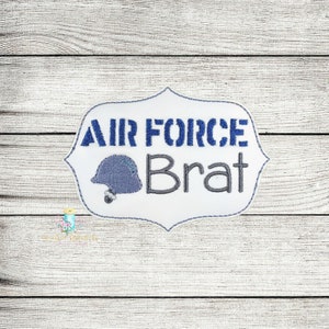 May include: White embroidered patch with a blue helmet and the text "AIR FORCE Brat" in blue and gray lettering.