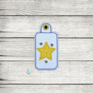 May include: A white key tag with a blue border and a large yellow star in the center. There are four smaller blue stars around the large star.
