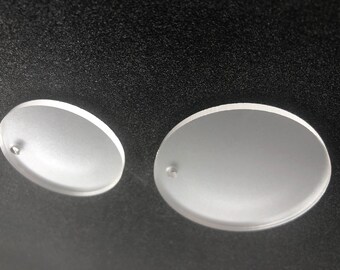 May include: Two white, round, frosted glass discs with a small hole in the center of each disc.