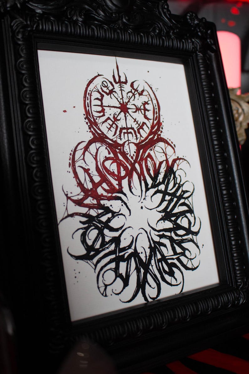 May include: A framed black and white print with a red and black design. The design features a compass with a circle of runes around it. The word "SPIRIT" is written in a stylized font around the compass.