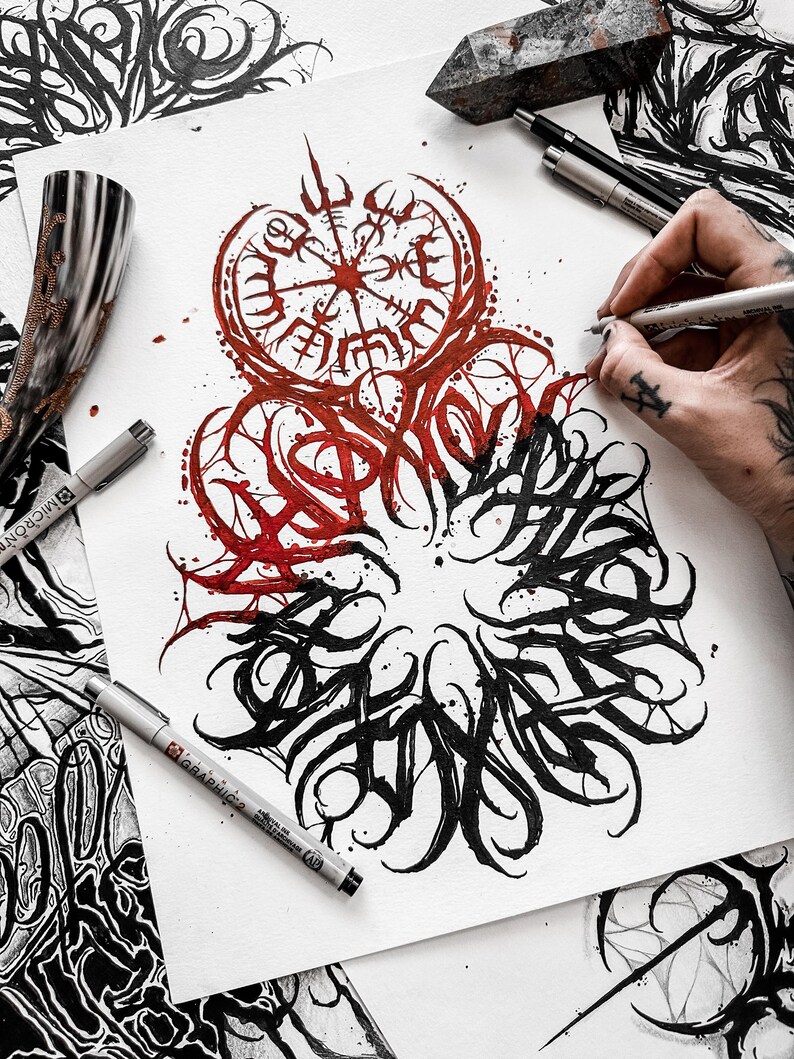 May include: A black and white ink drawing of a compass with a red and black design. The compass is surrounded by a circle of black ink with a stylized design. The drawing is on a white piece of paper.