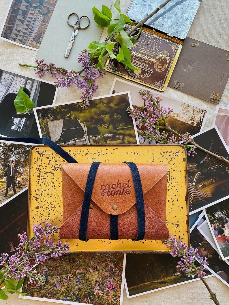 rustic natural leather envelope wrapped with a navy blue stripe and embossed with custom logo