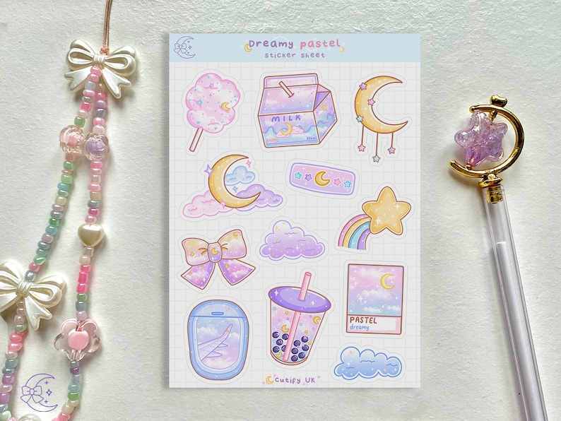 May include: A sheet of pastel-themed stickers featuring a cotton candy, milk carton, crescent moons, clouds, a rainbow, a star, a bow, a boba drink, and an airplane window. The text "Dreamy pastel" and "Cutify UK" are visible.