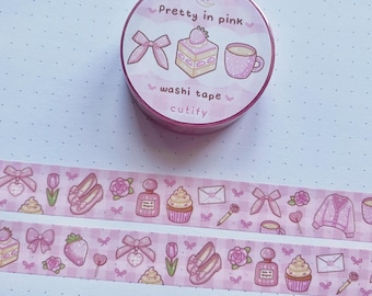 May include: Pink washi tape with a checkered pattern and illustrations of cupcakes, perfume bottles, flowers, shoes, bows, and a cardigan. The tape is rolled up in a pink container with the text "Pretty in pink" and "washi tape cutify".