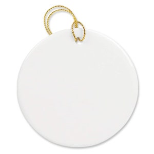 May include: A white ceramic ornament with a gold string attached. The ornament is round and has a smooth surface.