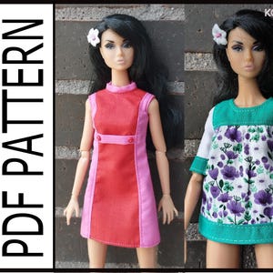 May include: Two doll outfits are shown. The first is a red and pink dress with a high neckline and two buttons. The second is a white top with purple floral print, green trim, and short sleeves. The text "PDF PATTERN" is on the left.