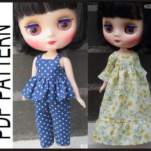 May include: Two dolls wearing different outfits. The doll on the left is wearing a blue and white polka dot jumpsuit. The doll on the right is wearing a yellow and white floral dress. Both dolls have black hair and large blue eyes.