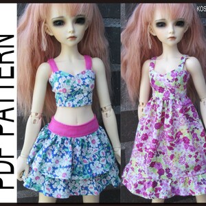 May include: Two doll outfits with floral patterns. The first outfit is a blue and white crop top with a pink skirt. The second outfit is a purple and white dress. Both outfits have a floral pattern.