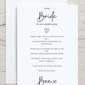 May include: A white wedding card with the words "To My Bride" in elegant script. The card includes a heartfelt message and is signed "Ben x". The card is placed inside a white envelope.