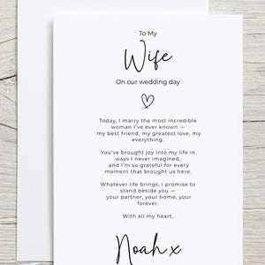 May include: A white wedding card with the words "To My Wife" in elegant script. The card includes a heartfelt message and is signed "Noah x". The card is placed inside a white envelope.