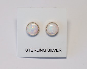 May include: A pair of sterling silver stud earrings with white opal stones.