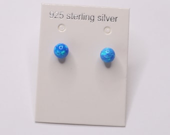 May include: A pair of blue opal stud earrings on a white card with the text "925 sterling silver".