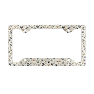May include: A white license plate frame with a pattern of brown, gray, and black paw prints.
