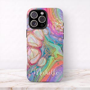 May include: A smartphone case featuring a vibrant, multi-colored fluid acrylic pour design with swirling patterns of pink, blue, green, and orange, accented by thin gold lines. The name Michelle is printed in a white cursive script at the bottom.