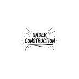 May include: A white sticker with the words "UNDER CONSTRUCTION" in a black, handwritten font. The text is surrounded by radiating lines, giving the impression of a burst or explosion. The sticker is likely used for labeling or decoration.