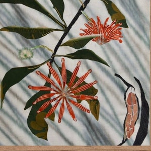 May include: A framed botanical print featuring a stylized branch with red flowers and green leaves on a blue and white striped background.