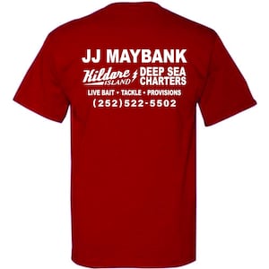 May include: A red short-sleeved t-shirt featuring white text on the back that reads JJ MAYBANK, Kildare ISLAND DEEP SEA CHARTERS, LIVE BAIT TACKLE PROVISIONS, and the phone number (252)522-5502, with a lightning bolt icon between the words.