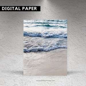 May include: A digital paper featuring a close-up of ocean waves crashing on a sandy beach. The water is a light blue and the sand is a light beige.