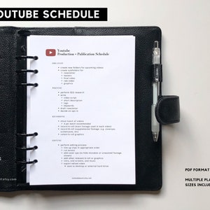May include: A black and white printable YouTube production and publication schedule planner in a black ring binder. The planner includes sections for organizing, writing, recording, and editing videos. The planner is available in multiple sizes and PDF format.