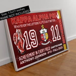 May include: A framed print with a red background features the text "KAPPA ALPHA PSI" and "1911" in white. A drawing of a man in a red suit is on the left. The print is 11x17 inches. The words "BROTHERHOOD" and "ACHIEVEMENT IN EVERY FIELD" are also visible.