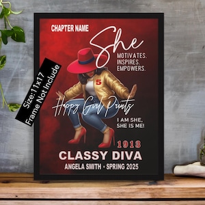 May include: A framed print with a red background featuring a woman wearing a red hat and a gold jacket. The text "She motivates. Inspires. Empowers." is above the woman. The text "Happy Girl Prints" is below the woman. The text "I am she, she is me!" is below the woman. The text "1913 Classy Diva" is below the woman. The text "Angela Smith Spring 2025" is below the woman.