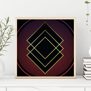 May include: A framed geometric print with a black background and a gold diamond shape in the center. The diamond is surrounded by a circle of red and purple lines radiating outward.