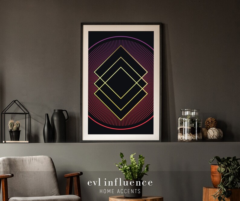 May include: A framed geometric print with a black background and a gold and red design. The design features a series of overlapping squares with a radiating pattern of lines in shades of red and gold. The print is titled "evil influence" and "HOME ACCENTS".