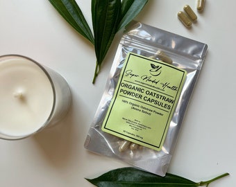 May include: A silver pouch containing 50 capsules of organic oatstraw powder. The pouch has a green label with the text "Super Minded Health" and "Organic Oatstraw Powder Capsules".