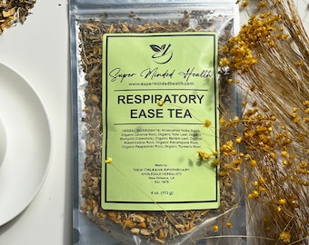 May include: A green and white resealable pouch of Respiratory Ease Tea by Super Minded Health. The pouch contains a blend of dried herbs and the label lists the ingredients: Wildcrafted Yerba Santa, Organic Licorice Root, Organic Tulsi Leaf, Organic Marigold (Calendula), Organic Mullein Leaf, Organic Marshmallow Root, Organic Elecampane Root, Organic Peppermint Root, Organic Turmeric Root. The pouch is made by New Orleans Apothecary Wholesale Herbalists, Est. 1979. The pouch contains 113 g of tea.