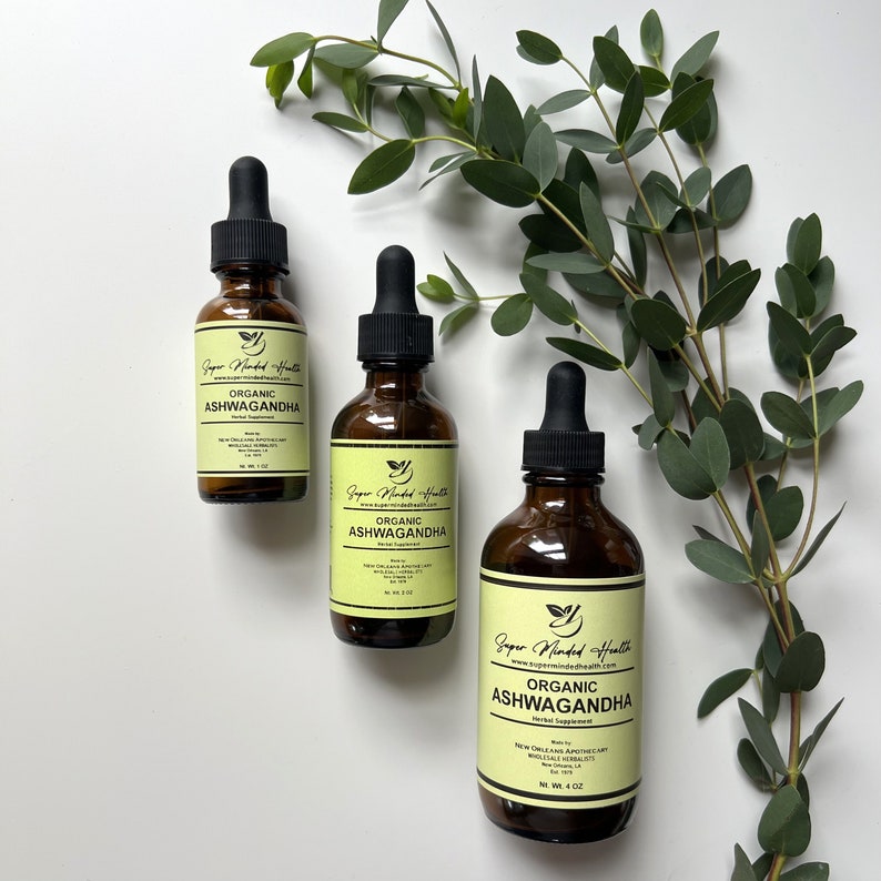 May include: Three amber glass bottles with dropper tops containing organic ashwagandha herbal supplement. The bottles are labelled with the brand name "Super Minded Health" and the product name "Organic Ashwagandha".