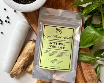 May include: A white and yellow label with the text "Super Minded Health" and "Intestinal Formula #1" on a clear plastic bag with a zipper closure. The label lists the ingredients, including organic cascara sagrada, ginger root, and barberry root bark. The bag contains 50 capsules, each 500 mg.