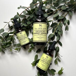 May include: Three glass bottles with dropper tops containing a dark liquid. The bottles are labelled "Super Minded Health" and "Pure Non-GMO Soursop Graviola Herbal Supplement".