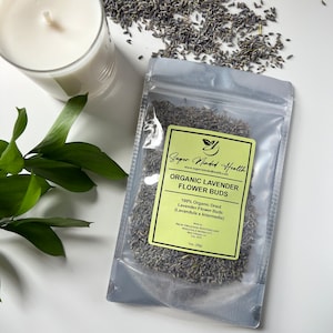 May include: A clear plastic bag filled with dried lavender flower buds. The bag has a yellow label with the text "Super Minded Health" and "Organic Lavender Flower Buds". The label also includes the text "100% Organic Dried Lavender Flower Buds (Lavandula x Intermedia)".